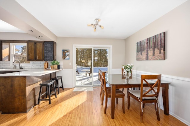 dining space featuring light hardwood / wood-style floors and sink