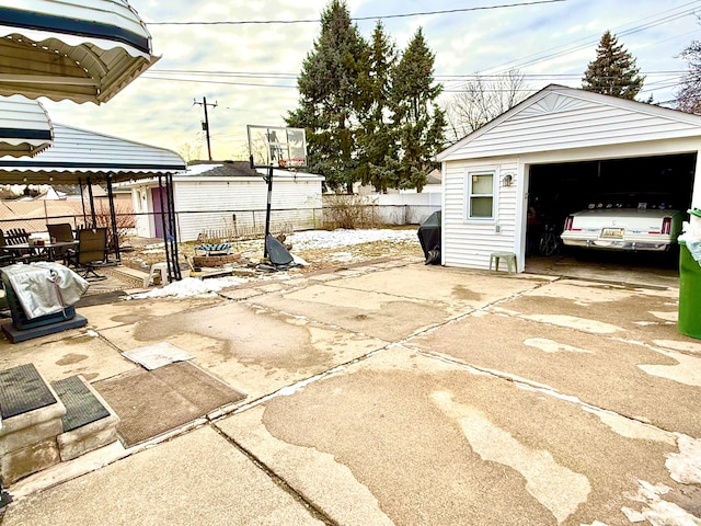 view of patio / terrace featuring a garage, an outdoor structure, and a gazebo