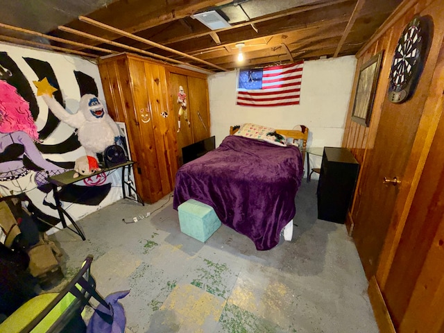 bedroom featuring concrete flooring