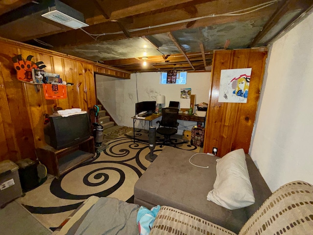 basement featuring wood walls