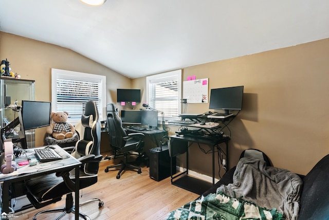 home office featuring vaulted ceiling and light wood-type flooring