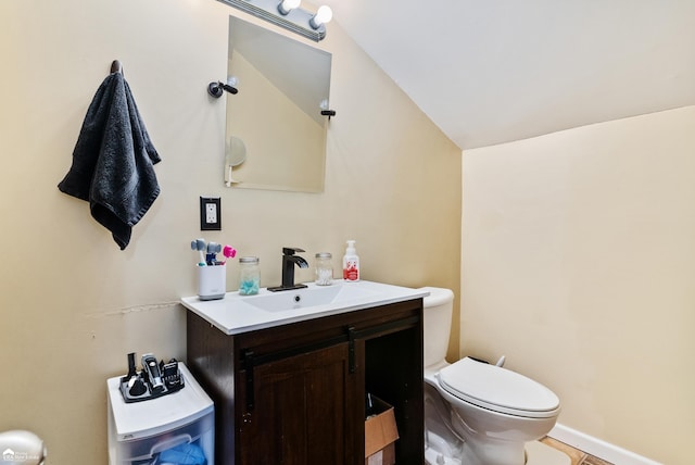 bathroom featuring vanity, tile patterned floors, toilet, and lofted ceiling