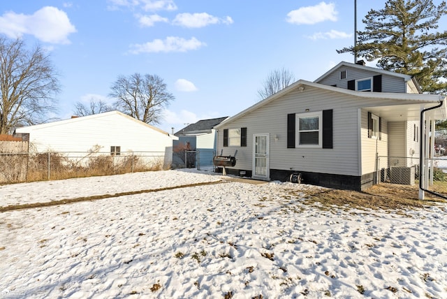 view of snow covered rear of property