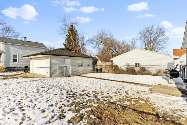 snow covered house with an outbuilding and a garage