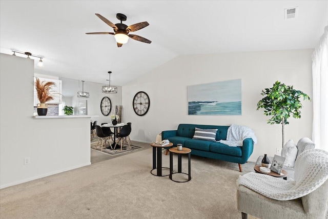 living room featuring ceiling fan, light colored carpet, and vaulted ceiling