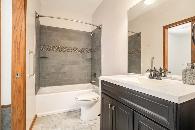 full bathroom featuring tiled shower / bath, vanity, and toilet