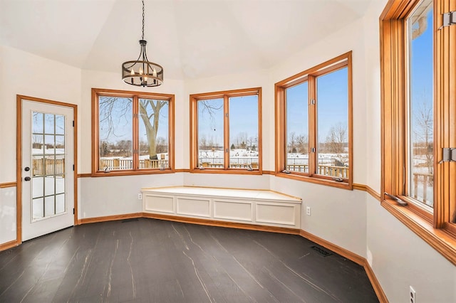 unfurnished sunroom with an inviting chandelier, vaulted ceiling, and a healthy amount of sunlight