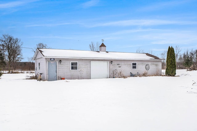 snow covered house with a garage