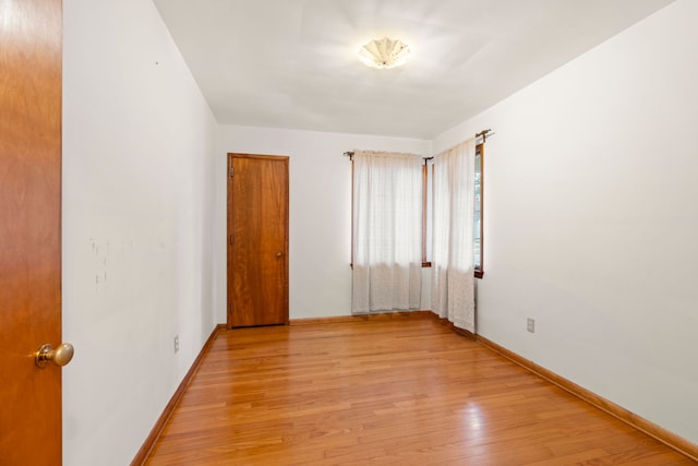 spare room featuring light hardwood / wood-style flooring