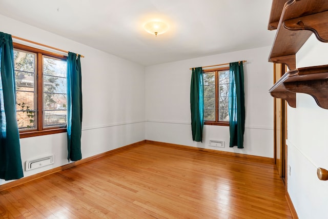 empty room with light hardwood / wood-style flooring