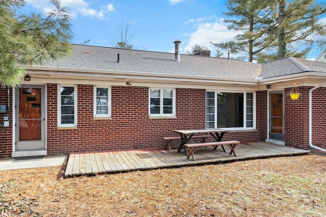 back of property with a wooden deck