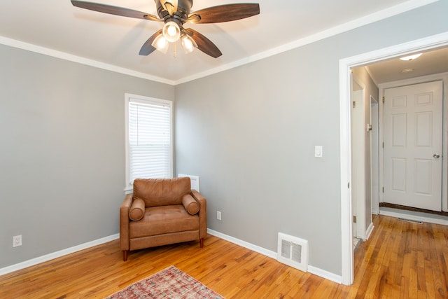 sitting room featuring crown molding, ceiling fan, and light wood-type flooring