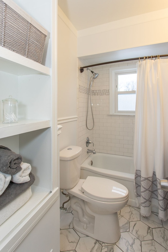 bathroom featuring shower / bath combo and toilet