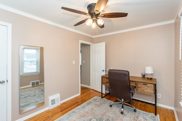 office area with ceiling fan, ornamental molding, and light wood-type flooring