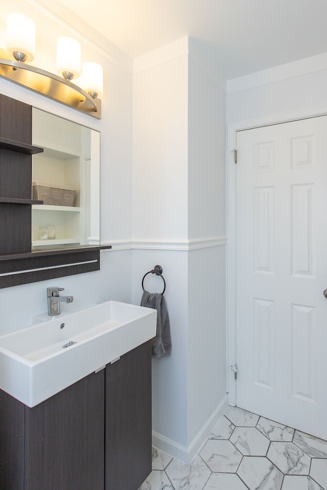 bathroom with crown molding and vanity