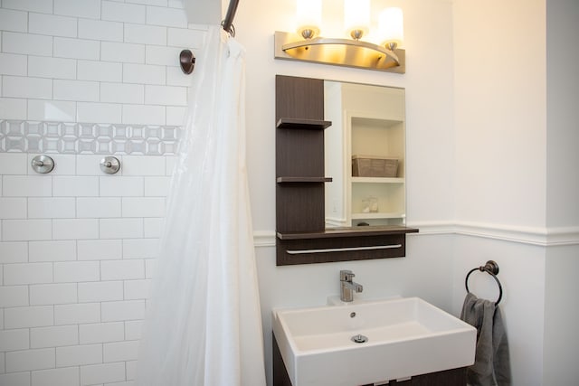 bathroom with sink and a shower with shower curtain