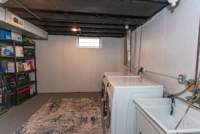 clothes washing area with sink and washer and dryer