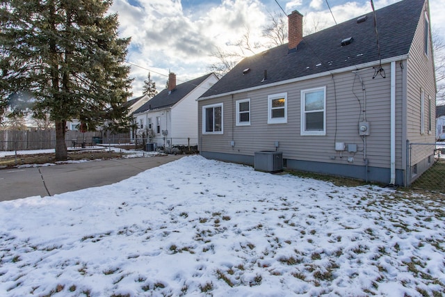 snow covered property featuring central air condition unit