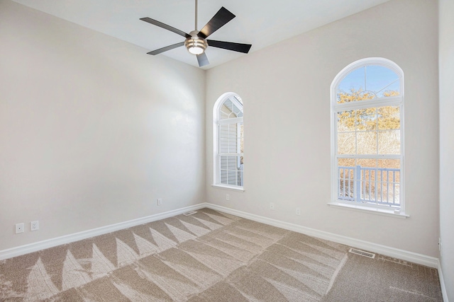 carpeted empty room featuring ceiling fan