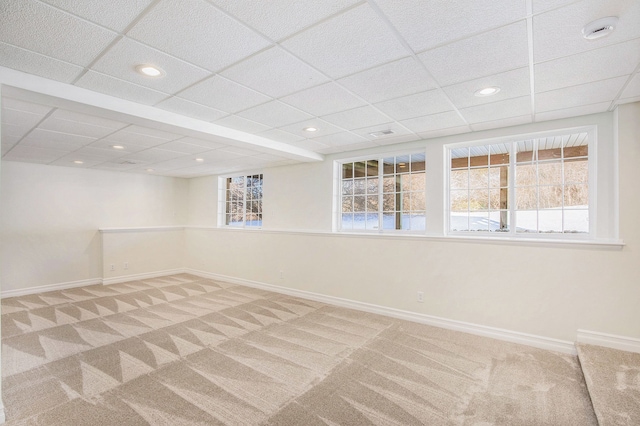 unfurnished room featuring carpet and a paneled ceiling