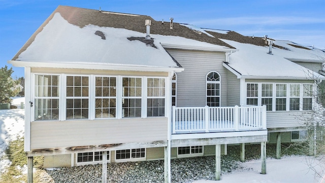 view of snow covered rear of property