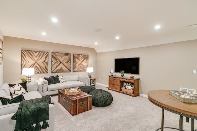 living room featuring light carpet and vaulted ceiling