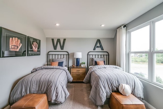 bedroom featuring multiple windows and dark colored carpet