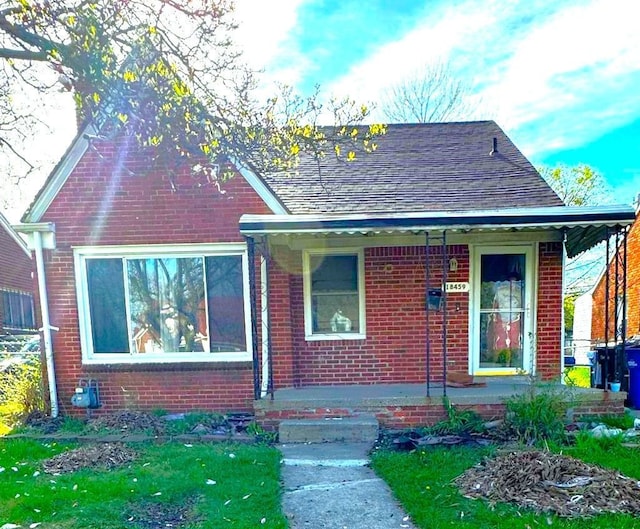 bungalow featuring a front yard and covered porch