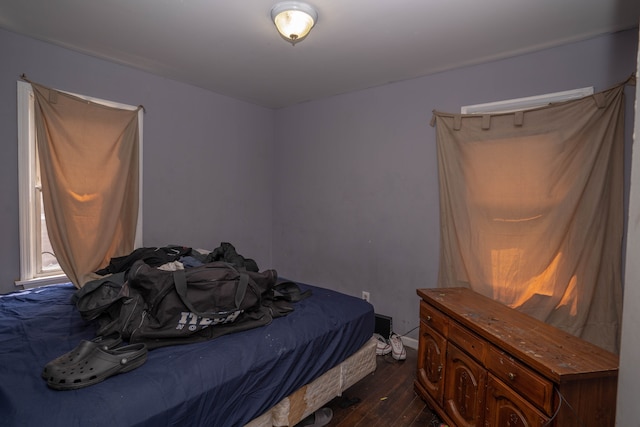 bedroom with dark wood-type flooring