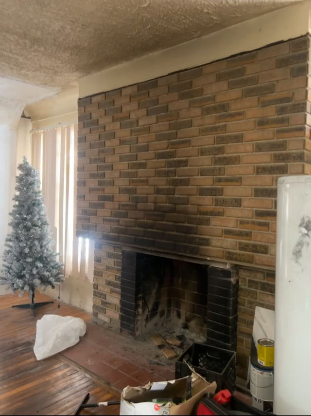 details with water heater, a fireplace, wood-type flooring, and a textured ceiling