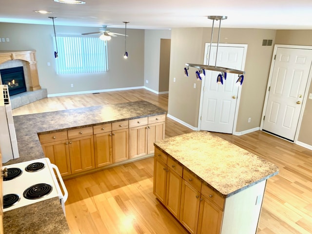 kitchen featuring light wood-style flooring, ceiling fan, white range with electric stovetop, and visible vents