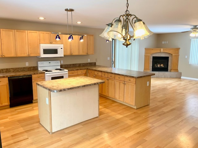 kitchen featuring light brown cabinetry, white appliances, light wood-type flooring, and a peninsula