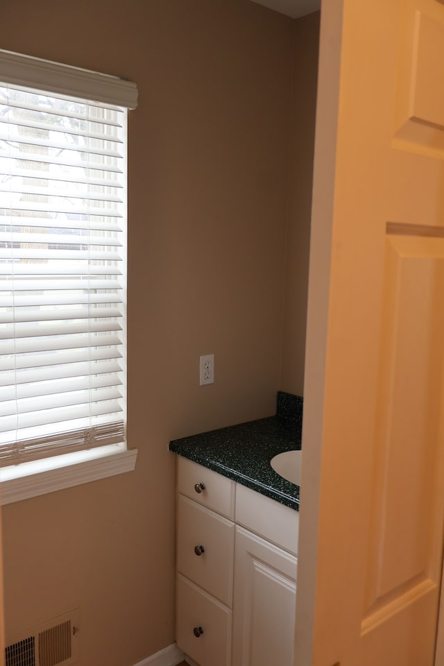 bathroom with vanity and visible vents