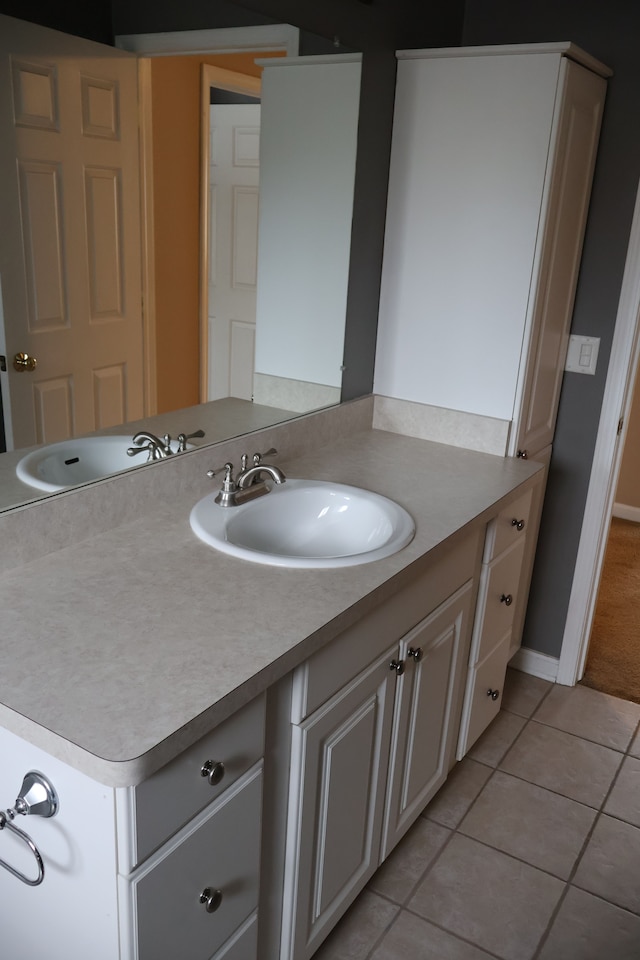 bathroom featuring vanity, tile patterned floors, and baseboards