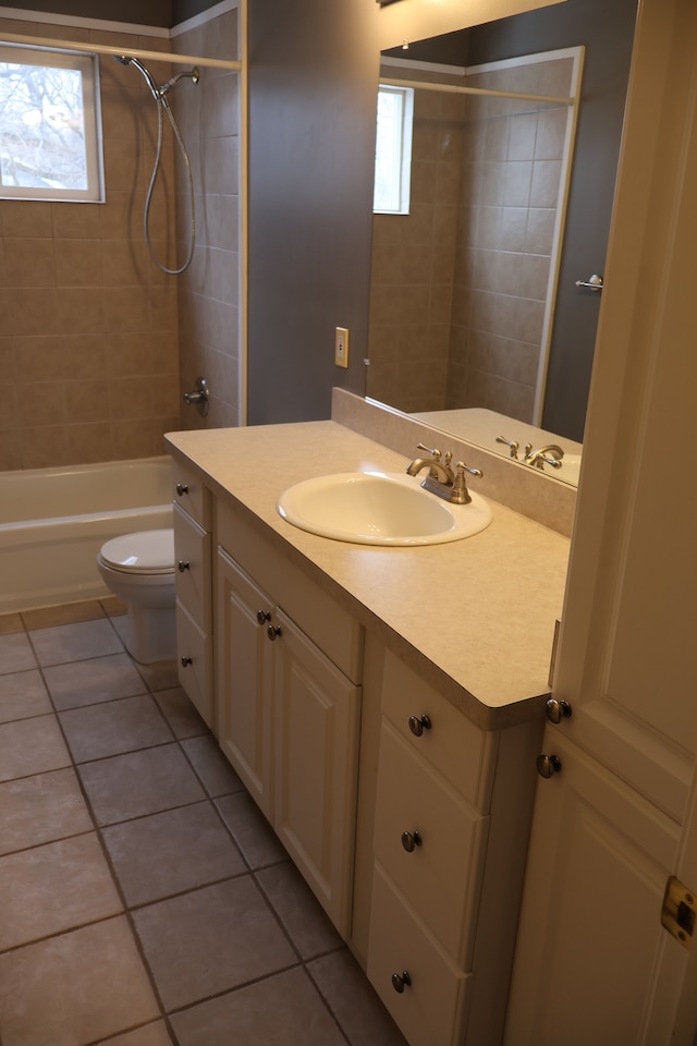 full bath featuring vanity, toilet, a healthy amount of sunlight, and shower / bath combination