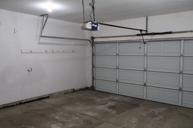 garage featuring a garage door opener and baseboards