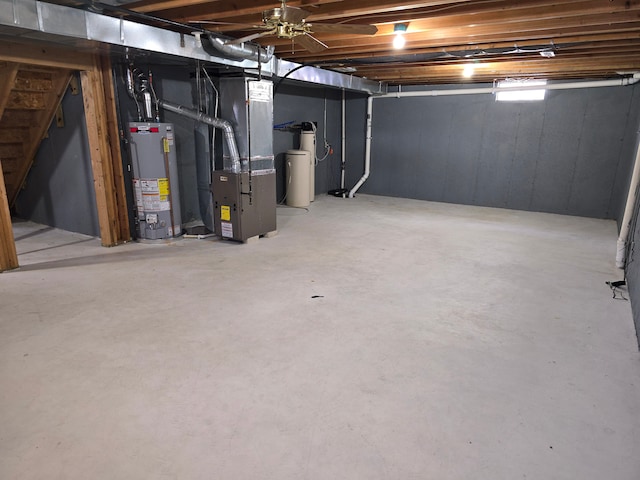 unfinished basement with stairs, heating unit, and gas water heater