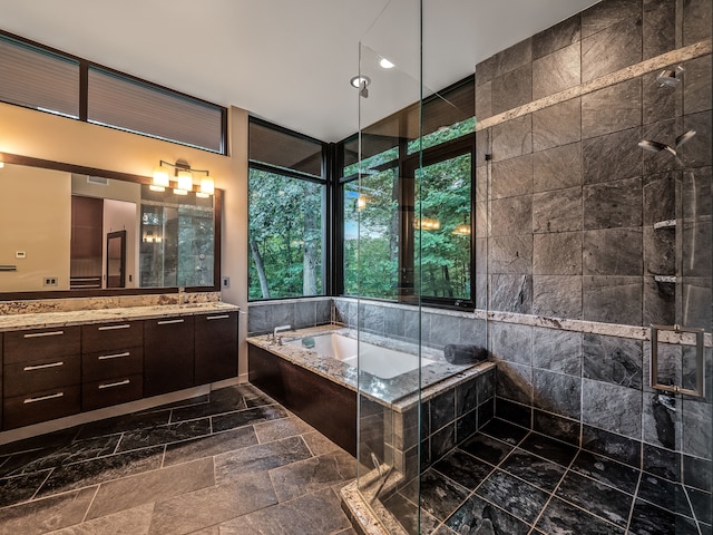 bathroom featuring vanity and separate shower and tub