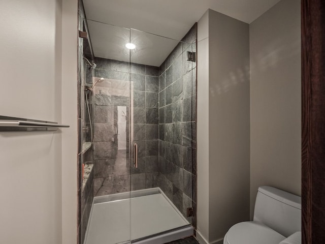 bathroom featuring an enclosed shower and toilet