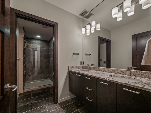 bathroom featuring vanity and a shower with shower door