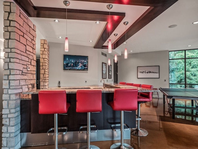 bar with concrete floors and decorative light fixtures