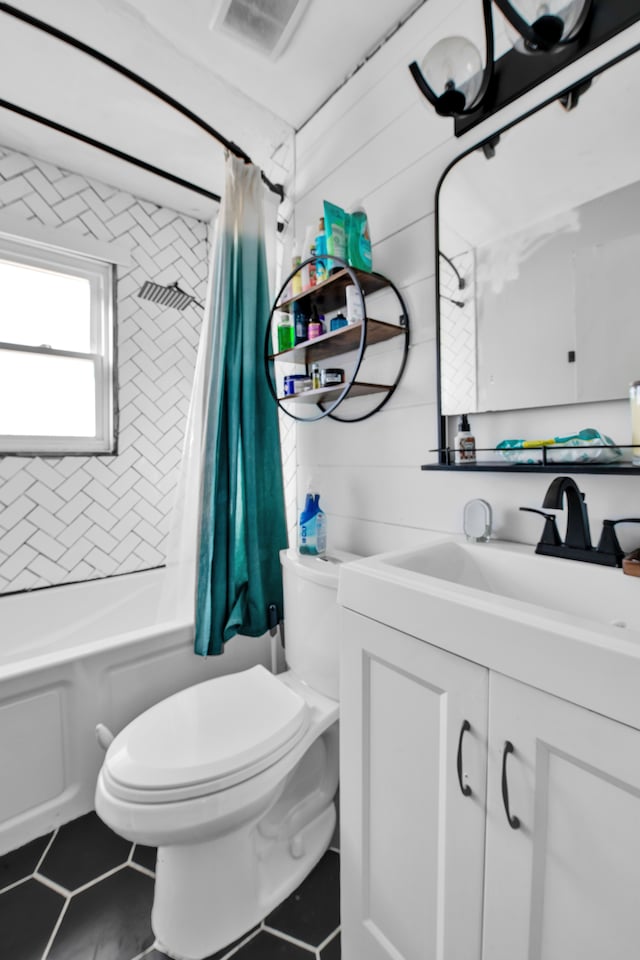 full bathroom featuring shower / tub combo with curtain, vanity, toilet, and tile patterned floors