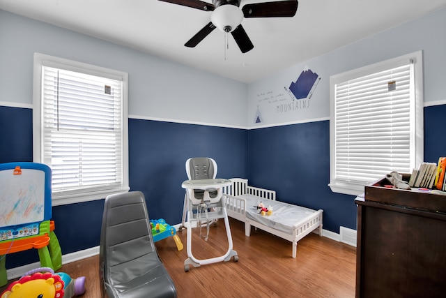 bedroom with ceiling fan and hardwood / wood-style floors