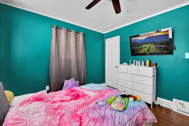 bedroom featuring wood-type flooring, ornamental molding, and ceiling fan