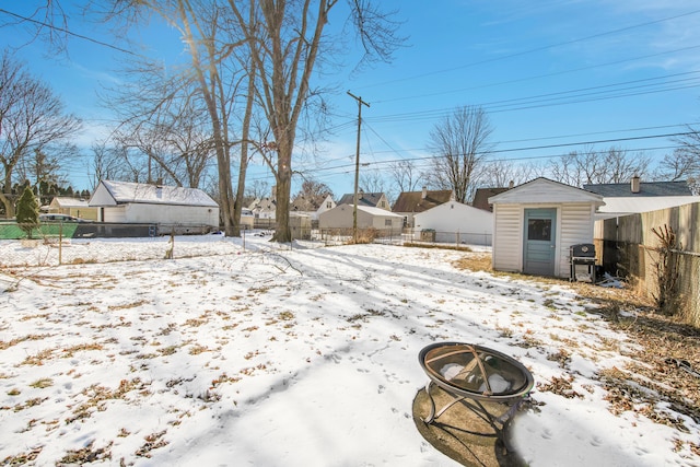 snowy yard with a fire pit