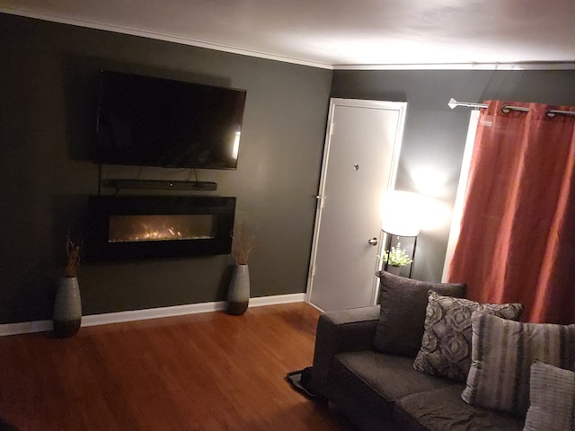 living room featuring hardwood / wood-style flooring and ornamental molding