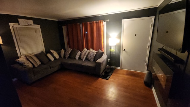 living room featuring ornamental molding and wood-type flooring