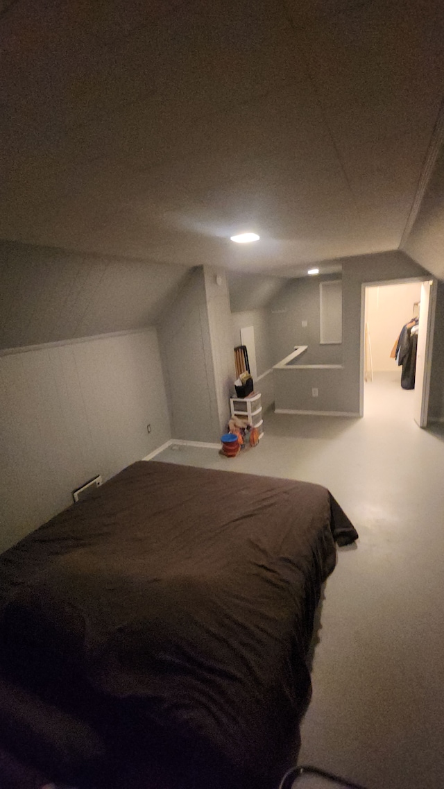 carpeted bedroom featuring lofted ceiling