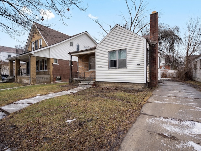 bungalow-style house with covered porch and a front yard