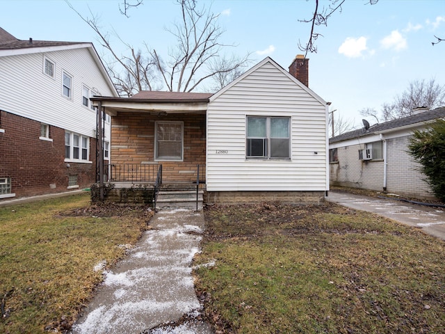 bungalow-style house with covered porch and a front lawn